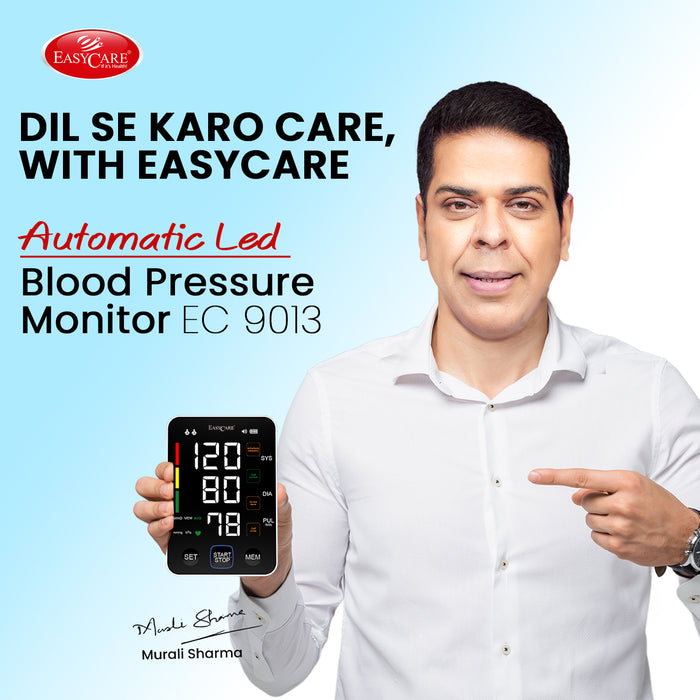 Man holding an Easycare blood pressure monitor with a blue background