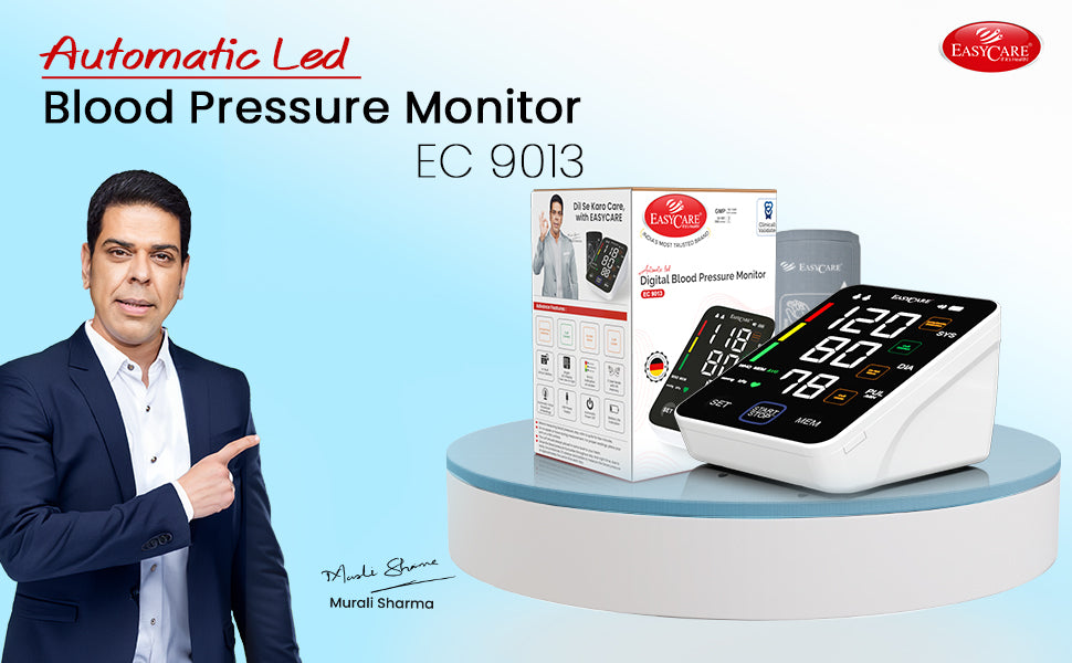 Blood pressure monitor with packaging and a person pointing at it on a blue background