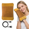 Polka dot hot water bag with yellow trim, power cord, and a woman holding the product.