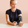 Woman using EASYCARE Aneroid Sphygmomanometer for manual blood pressure measurement at home
