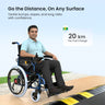 Person using a electric wheelchair with assist on a road, featuring text about battery life.