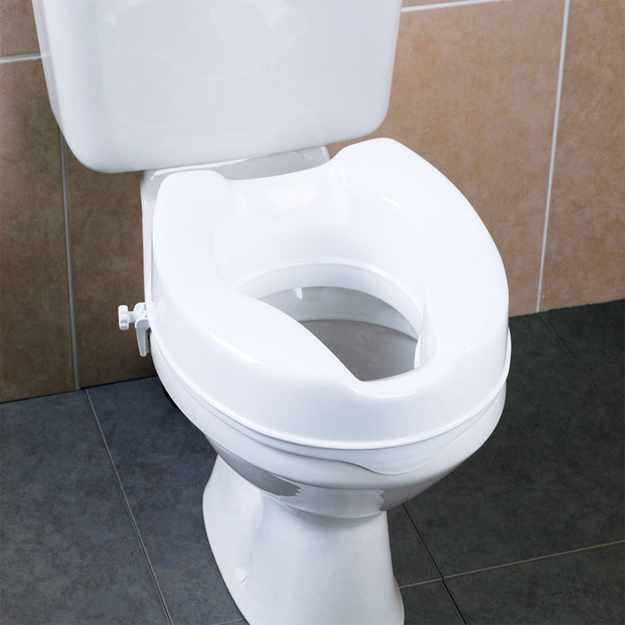 Toilet seat riser installed on commode